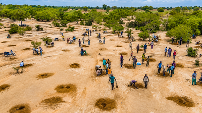 communities dig water harvesting pits to restore degraded land and improve soil moisture in the sahe