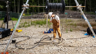 a worker prepares the well on a boston area horse farm to lower edens electrode