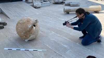 an archaeological amphora being photographed
