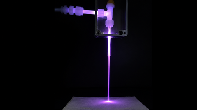 the prototype laundry gun in action during a fabric treatment test